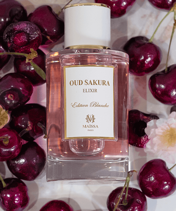 Luxurious Oud Sakura fragrance by Maison Maïssa, surrounded by cherries, reflecting its elegant and exclusive floral notes. Available at the5thscent.