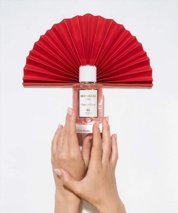 Luxurious Oud Sakura by Maison Maïssa held by hands, elegant cherry scent from the5thscent with a rich oriental touch.