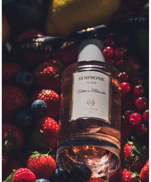 SYMPHONIE fragrance by Maison Maïssa nestled in fresh berries, showcasing its luxurious, fruity elegance. Available at the5thscent.