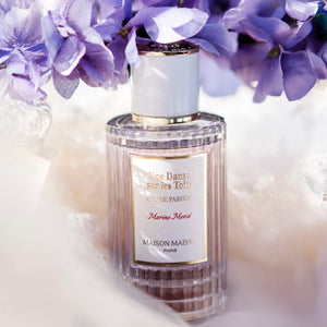 Maison Maïssa Une Danse sur les Toits perfume bottle surrounded by violet flowers