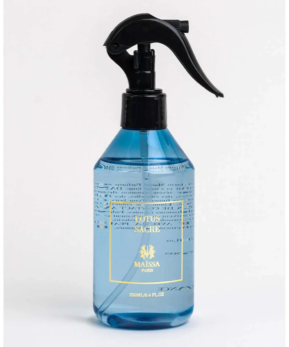 Blue spray bottle of Maïssa Paris Lotus Sacré perfume with black trigger nozzle on white background