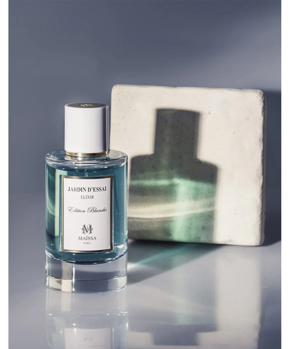 Jardin D'Essai Elixir Edition Blanche perfume bottle by Maïssa Paris with blue liquid
