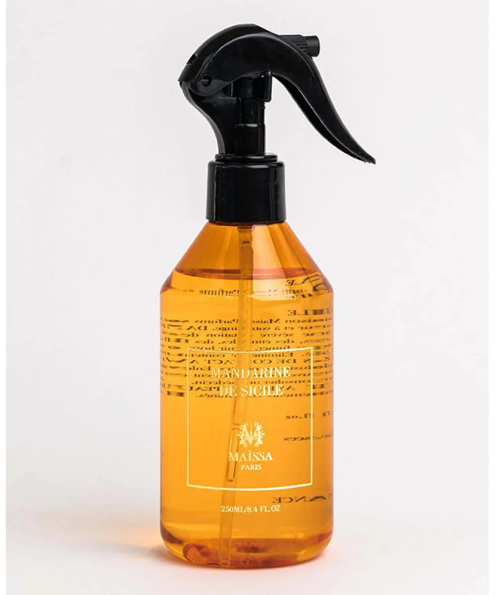 Orange liquid spray bottle labeled Mandarine De Sicile with black trigger nozzle on white background