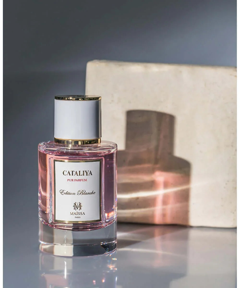 Cataliya Pur Parfum Edition Blanc perfume bottle with pink liquid, gold accents, and white cap