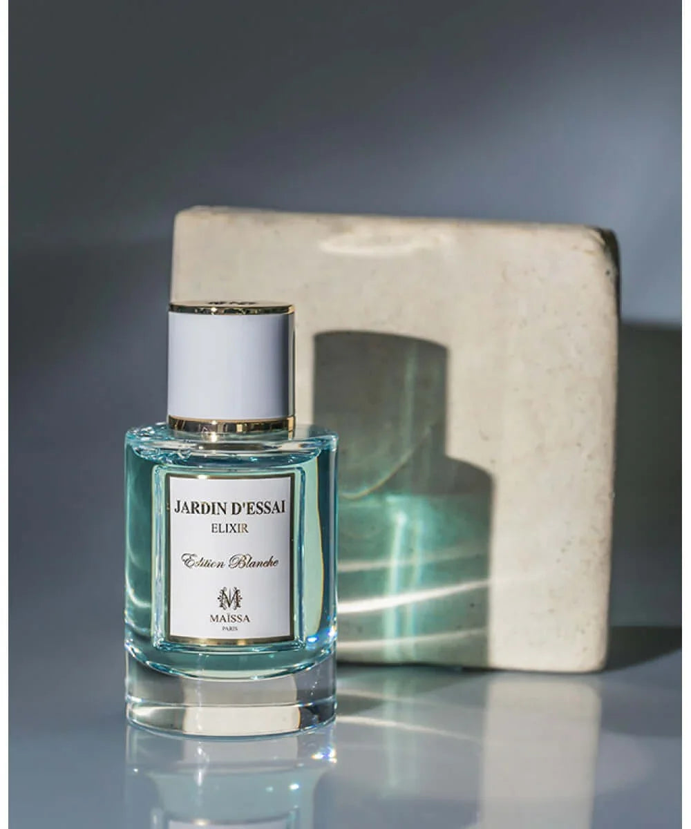 Jardin d'Essai Elixir Edition Blanche perfume bottle with light blue liquid and white gold-trimmed cap
