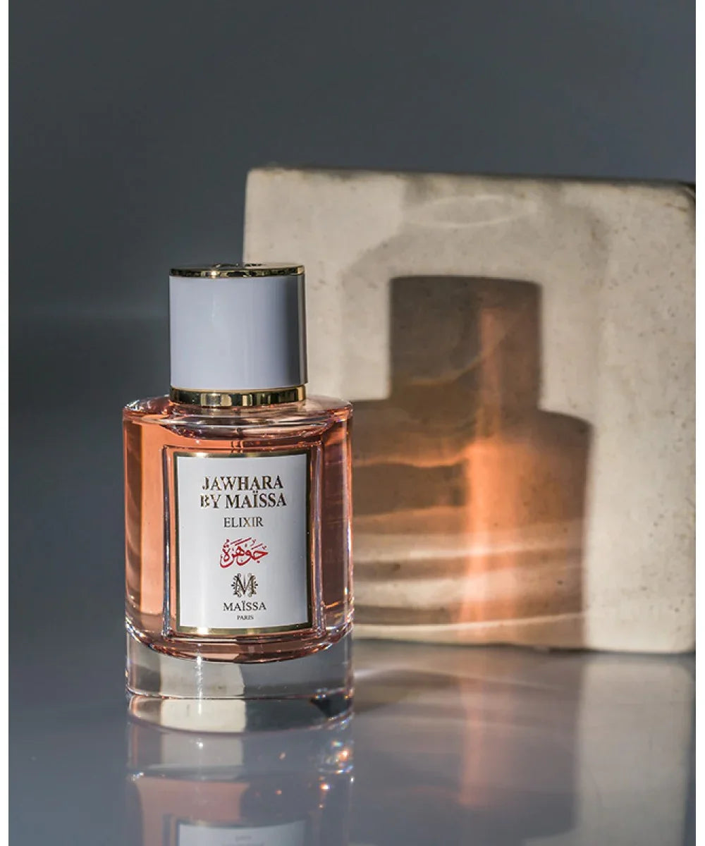 Jawhara by Maïssa Elixir perfume bottle with pink liquid and gold-trimmed white label